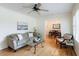 Cozy living room with hardwood floors, neutral paint, ceiling fan, and view of dining area at 3060 Wilson Rd, Decatur, GA 30033