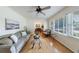 Bright living room features hardwood floors, neutral paint, ceiling fan, and large sunny window at 3060 Wilson Rd, Decatur, GA 30033