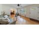 Open living room features hardwood floors, neutral paint, ceiling fan, and access to dining area at 3060 Wilson Rd, Decatur, GA 30033