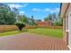 Spacious backyard featuring a wooden deck, a well-maintained lawn, and a wooden fence at 4129 Pepperdine Dr, Decatur, GA 30034