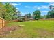 Expansive backyard with a wooden fence, featuring lush green grass and mature trees at 4129 Pepperdine Dr, Decatur, GA 30034