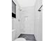Newly remodeled bathroom showcasing a tiled shower with a niche, a modern shower head, and a pebbled floor at 4129 Pepperdine Dr, Decatur, GA 30034