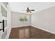 Cozy bedroom with hardwood floors, a ceiling fan, and a large window offering plenty of natural light at 4129 Pepperdine Dr, Decatur, GA 30034