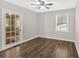 Bedroom featuring wood floors, a large window with blinds, and a glass French door, providing ample natural light at 4129 Pepperdine Dr, Decatur, GA 30034