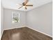 This cozy bedroom features hardwood floors, a ceiling fan, and a window to let in natural light at 4129 Pepperdine Dr, Decatur, GA 30034