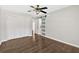 This bedroom features hardwood floors, ample closet space, a ceiling fan, and a unique glass sliding door at 4129 Pepperdine Dr, Decatur, GA 30034