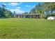 Spacious front yard of a well-kept single-story brick home with black shutters at 4129 Pepperdine Dr, Decatur, GA 30034