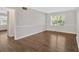 Open-concept living room featuring hardwood floors, wainscoting, and ample natural light at 4129 Pepperdine Dr, Decatur, GA 30034