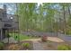 Serene backyard showcasing mature trees, privacy fencing, and beautifully landscaped garden beds at 1025 Saint Marks Walk, Suwanee, GA 30024