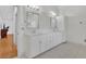 Bright bathroom featuring double sinks, stylish mirrors, and a large vanity at 1025 Saint Marks Walk, Suwanee, GA 30024