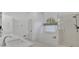 Modern bathroom with dual sinks, soaking tub, and a glass enclosed shower at 1025 Saint Marks Walk, Suwanee, GA 30024