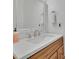 Bathroom with a granite countertop, modern faucet, and a large framed mirror at 1025 Saint Marks Walk, Suwanee, GA 30024