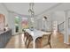 Spacious dining room with large windows, modern light fixtures, and hardwood flooring at 1025 Saint Marks Walk, Suwanee, GA 30024
