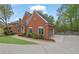 Well-maintained brick home with a spacious driveway, attached garage, and neatly trimmed landscaping at 1025 Saint Marks Walk, Suwanee, GA 30024