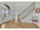 Bright and airy foyer with hardwood floors, a grand staircase, and an elegant entrance at 1025 Saint Marks Walk, Suwanee, GA 30024