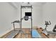 This home gym includes a treadmill and weight training machine at 1025 Saint Marks Walk, Suwanee, GA 30024