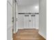 Bright hallway featuring wood floors and modern barn doors providing privacy and style at 1025 Saint Marks Walk, Suwanee, GA 30024