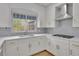 Bright kitchen featuring white cabinets, granite countertops, stainless steel appliances, and modern fixtures at 1025 Saint Marks Walk, Suwanee, GA 30024