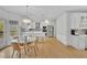 Bright kitchen featuring an eat-in area, a glass-topped table, white cabinets, and stainless steel appliances at 1025 Saint Marks Walk, Suwanee, GA 30024