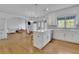 Bright kitchen featuring white cabinets, an island with bar seating, and an open concept design at 1025 Saint Marks Walk, Suwanee, GA 30024
