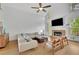 Bright living room with a vaulted ceiling, hardwood floors, fireplace, and modern furniture at 1025 Saint Marks Walk, Suwanee, GA 30024