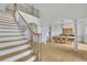 Bright foyer featuring a modern staircase with iron railings and a view into the dining room at 1025 Saint Marks Walk, Suwanee, GA 30024