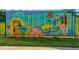 Community fence with a vibrant, colorful mural reflecting local art and Buford Highway community spirit at 3147 Buford Ne Hwy # 2, Atlanta, GA 30329