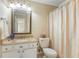 Bright bathroom featuring a single sink, granite countertops, and a shower with a colorful striped curtain at 3147 Buford Ne Hwy # 2, Atlanta, GA 30329
