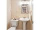 Cozy bathroom featuring a pedestal sink with a vanity mirror and a decorative glass bowl at 3147 Buford Ne Hwy # 2, Atlanta, GA 30329