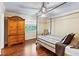 Bedroom with a wooden armoire, canopy bed, and hardwood floors offers a blend of comfort and style at 3147 Buford Ne Hwy # 2, Atlanta, GA 30329