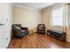 Comfortable bedroom space with hardwood floors, natural light, and well-placed accent furnishings at 3147 Buford Ne Hwy # 2, Atlanta, GA 30329