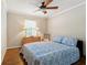 Relaxing bedroom with a wooden dresser, comfy bed, fan, and hardwood floors for a serene atmosphere at 3147 Buford Ne Hwy # 2, Atlanta, GA 30329