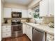 Cozy kitchen featuring white cabinets, stainless steel appliances, and a bright window at 3147 Buford Ne Hwy # 2, Atlanta, GA 30329