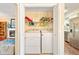 Convenient laundry area tucked behind closet doors, complete with washer, dryer, and shelving for optimal organization at 3147 Buford Ne Hwy # 2, Atlanta, GA 30329