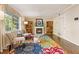 Comfortable living room featuring a cozy fireplace and natural light from the large window at 3147 Buford Ne Hwy # 2, Atlanta, GA 30329