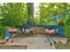 Brick patio area with outdoor tables, chairs, and red gas grills for resident use at 3147 Buford Ne Hwy # 2, Atlanta, GA 30329