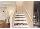 Bright stairway with wood steps and painted risers, featuring a sleek white handrail at 3147 Buford Ne Hwy # 2, Atlanta, GA 30329