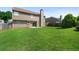 Expansive backyard featuring a lush green lawn and back of house with tan siding at 3235 Northcliff Dr, Suwanee, GA 30024