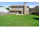 Spacious backyard with healthy green lawn, fenced property line, and tan siding at 3235 Northcliff Dr, Suwanee, GA 30024