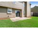 Home backyard with sliding glass doors, lawn, and tan siding at 3235 Northcliff Dr, Suwanee, GA 30024