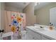 Cozy bathroom with floral shower curtain, with light paint at 3235 Northcliff Dr, Suwanee, GA 30024