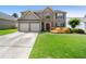 Charming two-story home featuring a two-car garage and lush, green lawn at 3235 Northcliff Dr, Suwanee, GA 30024
