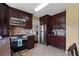 Kitchen showcasing stainless appliances, dark wood cabinets, and tile floors at 3235 Northcliff Dr, Suwanee, GA 30024