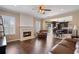 Open concept living area with fireplace flows into the updated kitchen with dining area and barstool seating at 3235 Northcliff Dr, Suwanee, GA 30024