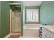 A well-lit main bathroom features a tub, shower, and neutral paint at 3235 Northcliff Dr, Suwanee, GA 30024