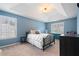 A main bedroom featuring a trey ceiling, two large windows and carpet at 3235 Northcliff Dr, Suwanee, GA 30024
