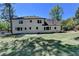 Exterior of the home showing the back, the lawn, and some mature trees at 5567 Stapleton Dr, Dunwoody, GA 30338