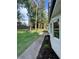Spacious backyard features lush lawn, concrete path and well-maintained landscaping at 5567 Stapleton Dr, Dunwoody, GA 30338