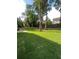 Large grassy backyard, partially fenced, with mature trees at 5567 Stapleton Dr, Dunwoody, GA 30338