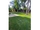 Large grassy backyard with a concrete path and mature trees at 5567 Stapleton Dr, Dunwoody, GA 30338